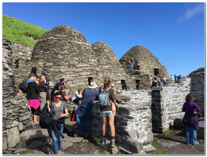 visitors at the beehive huts on skellig michael