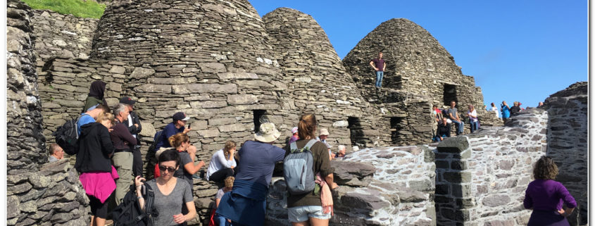 visitors at the beehive huts on skellig michael